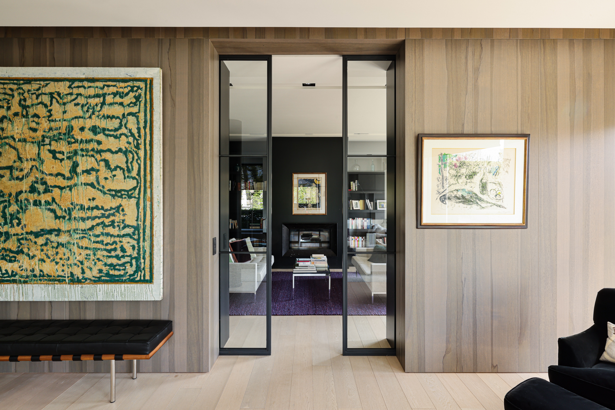 rénovation villa de luxe Belgique, lambris en bois sur mesure, porte coulissante intégrée en ferronnerie noire